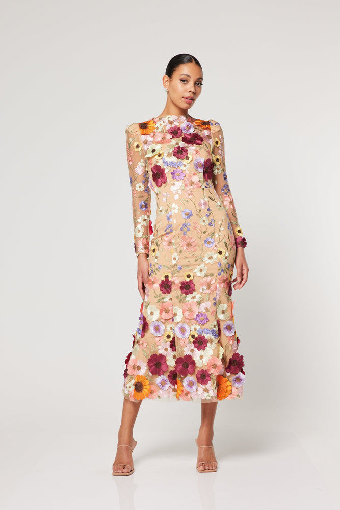The Shannon Midi dress by Elliatt is crafted with 3D colorful flower details. A sophisticated, feminine and striking midi dress design with long sheer sleeves. 